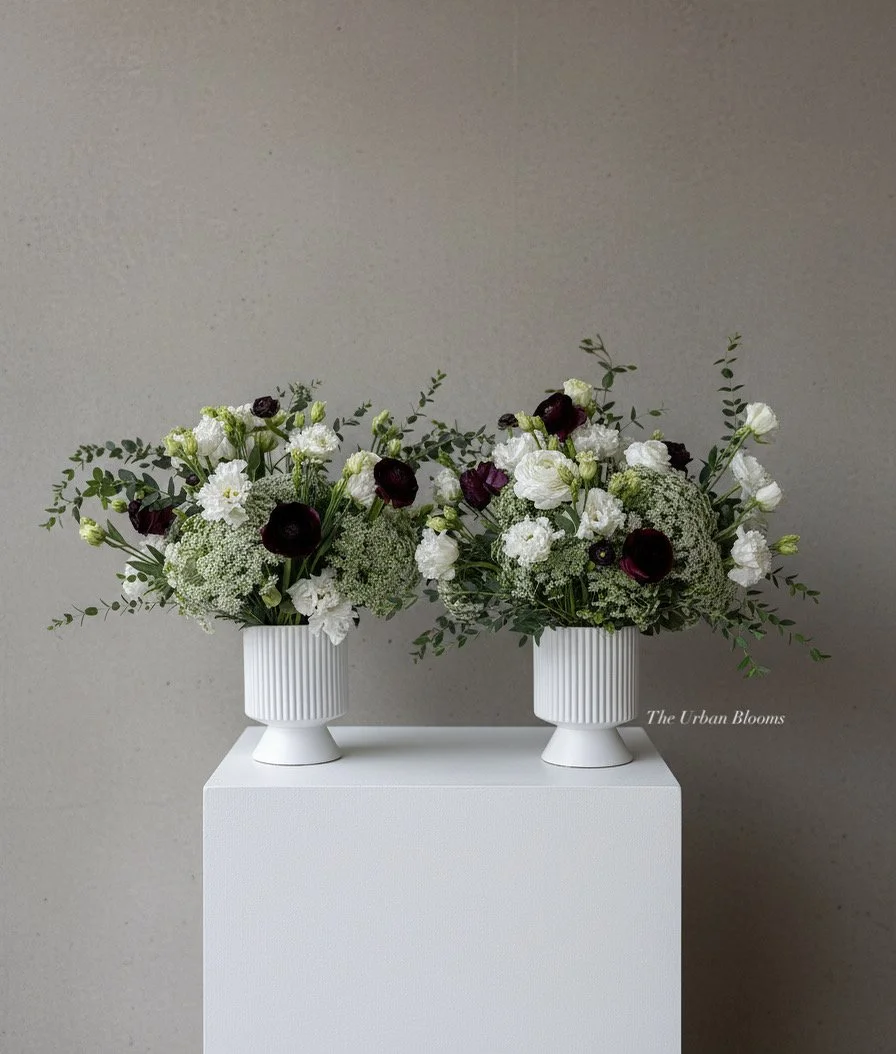 Fresh flower centrepieces with burgundy pops of color